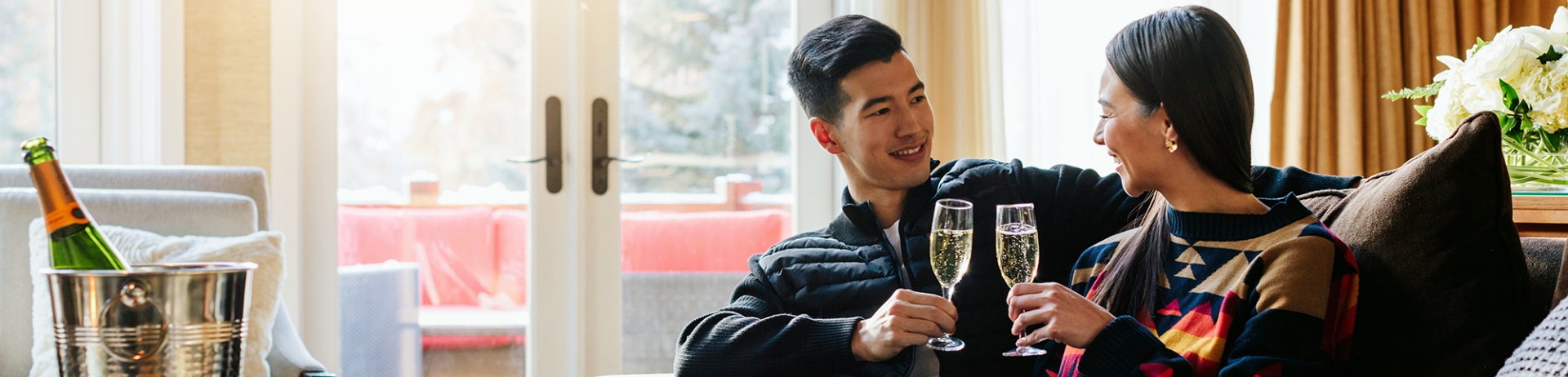Couple toasting champagne flutes in Stanley Thompson Cabin