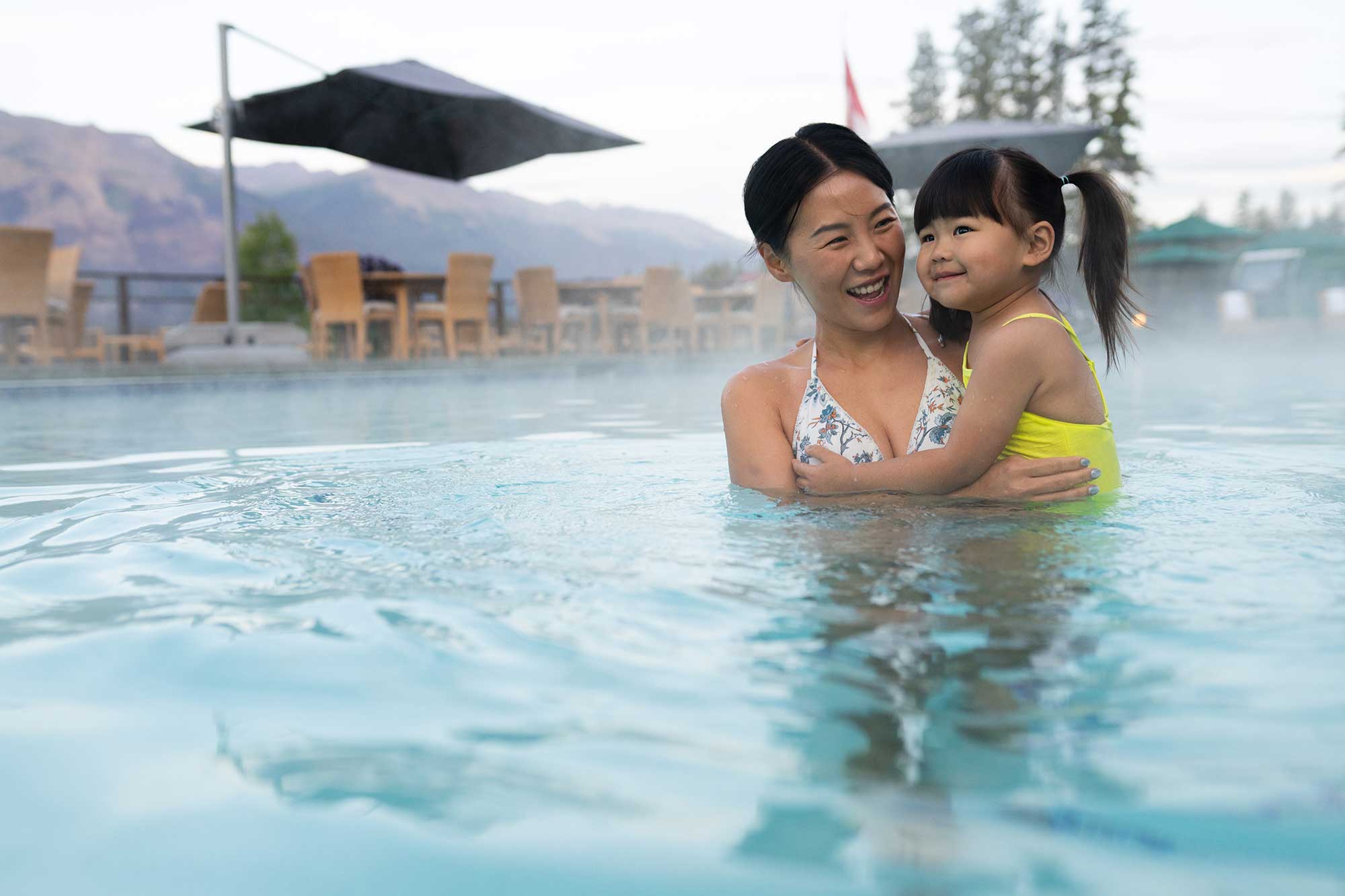 mother and daughter swimming in outdoor pool in jasper