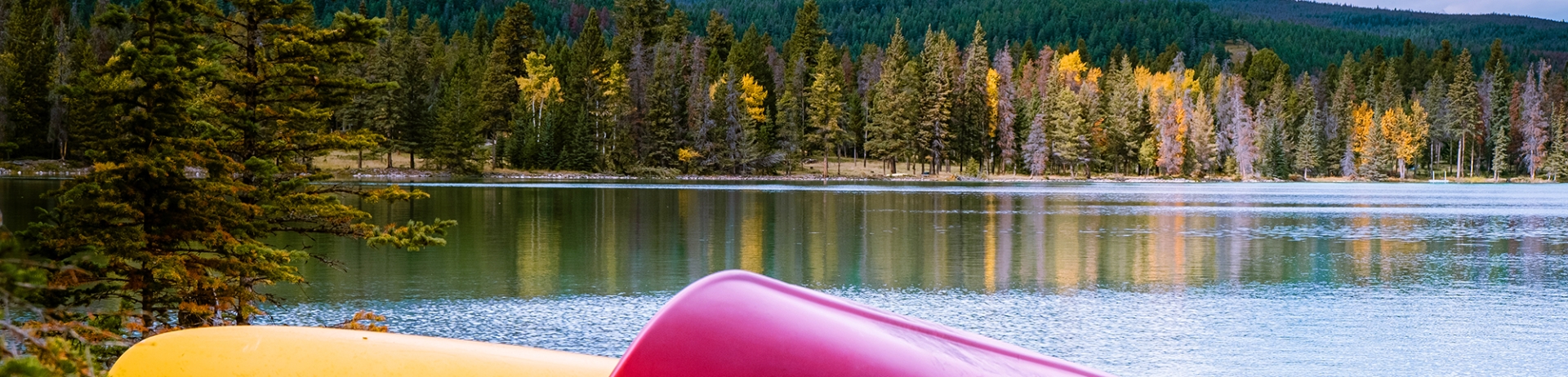 Canoe on dock beside lake