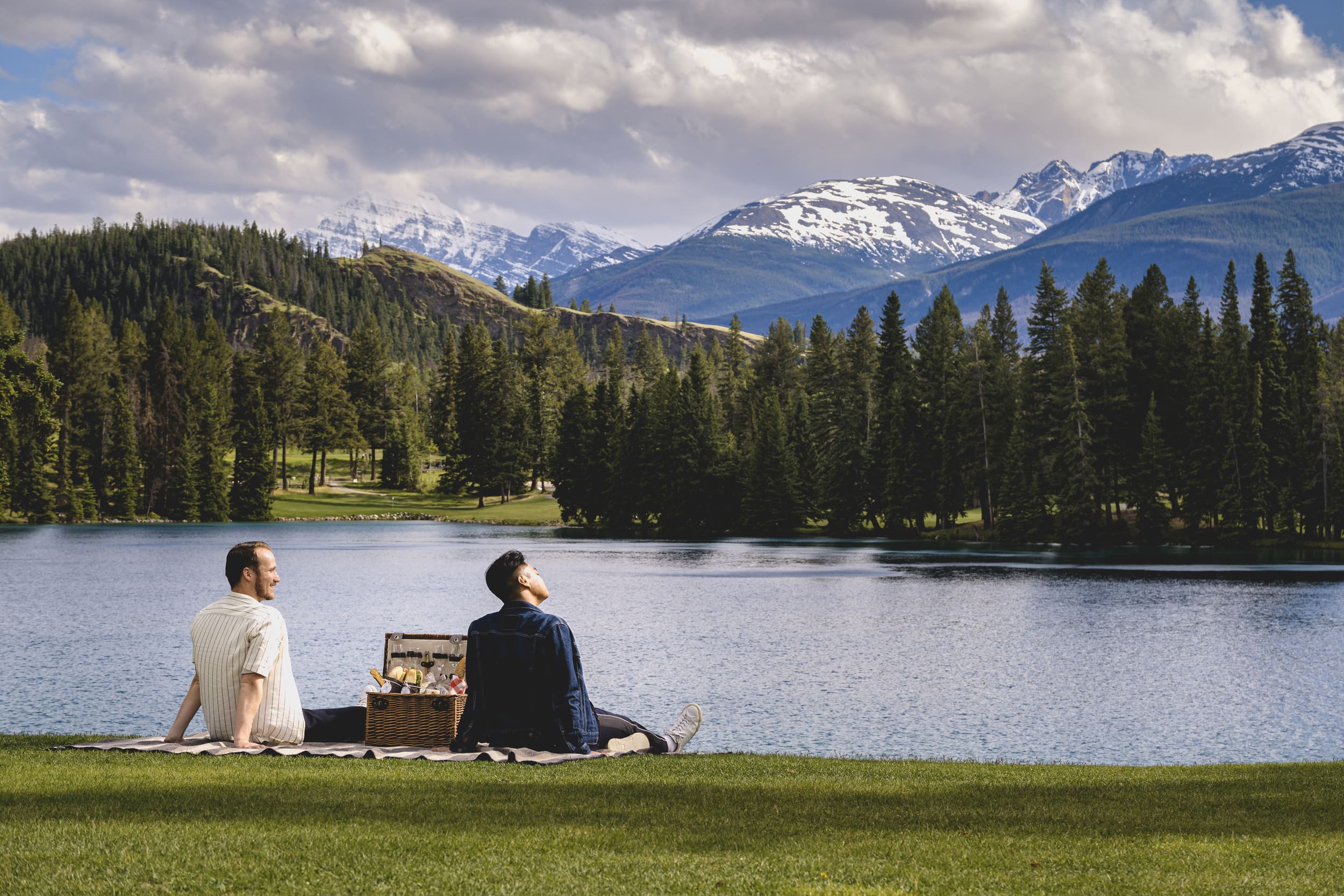 couple enjoying picnic by the lake