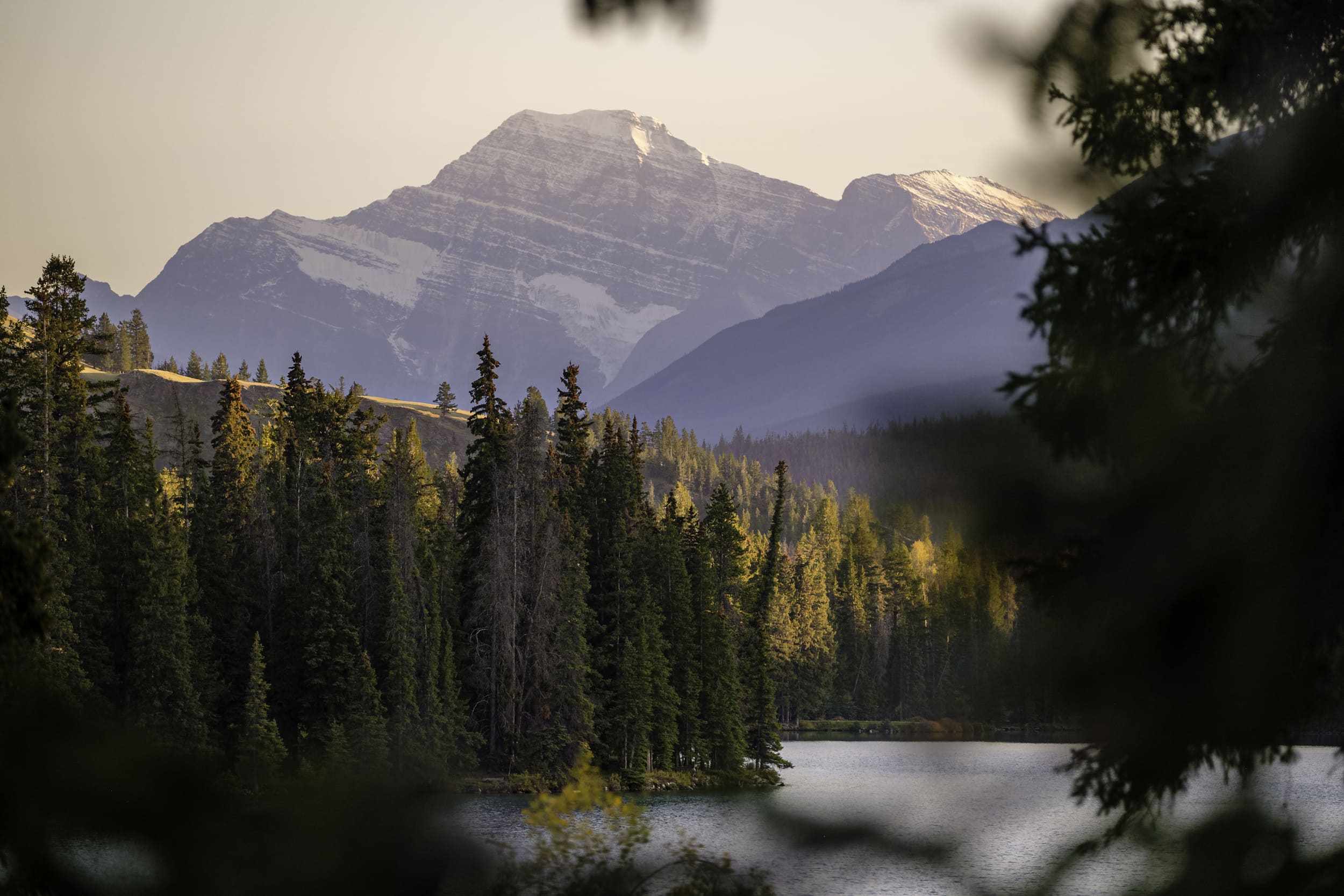 Scenic view of river and snow capped mountains