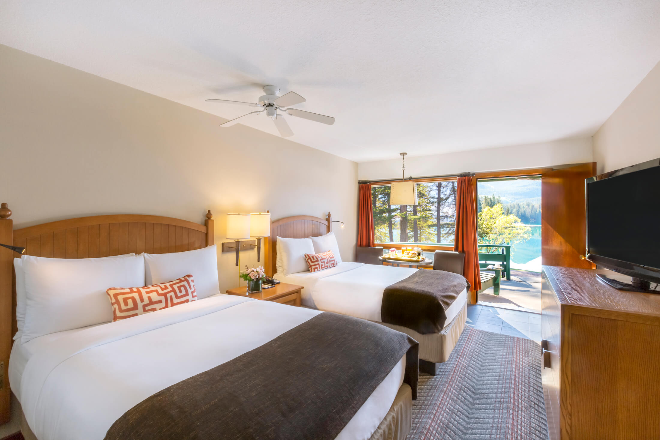 The interior of a two-bed hotel suite with mountain & lake views