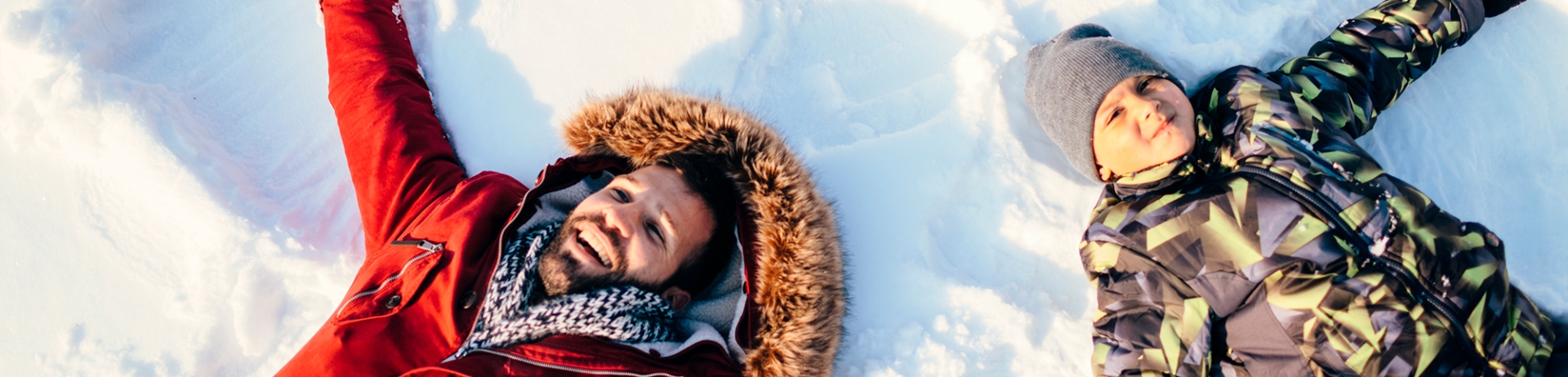 Family making snow angels