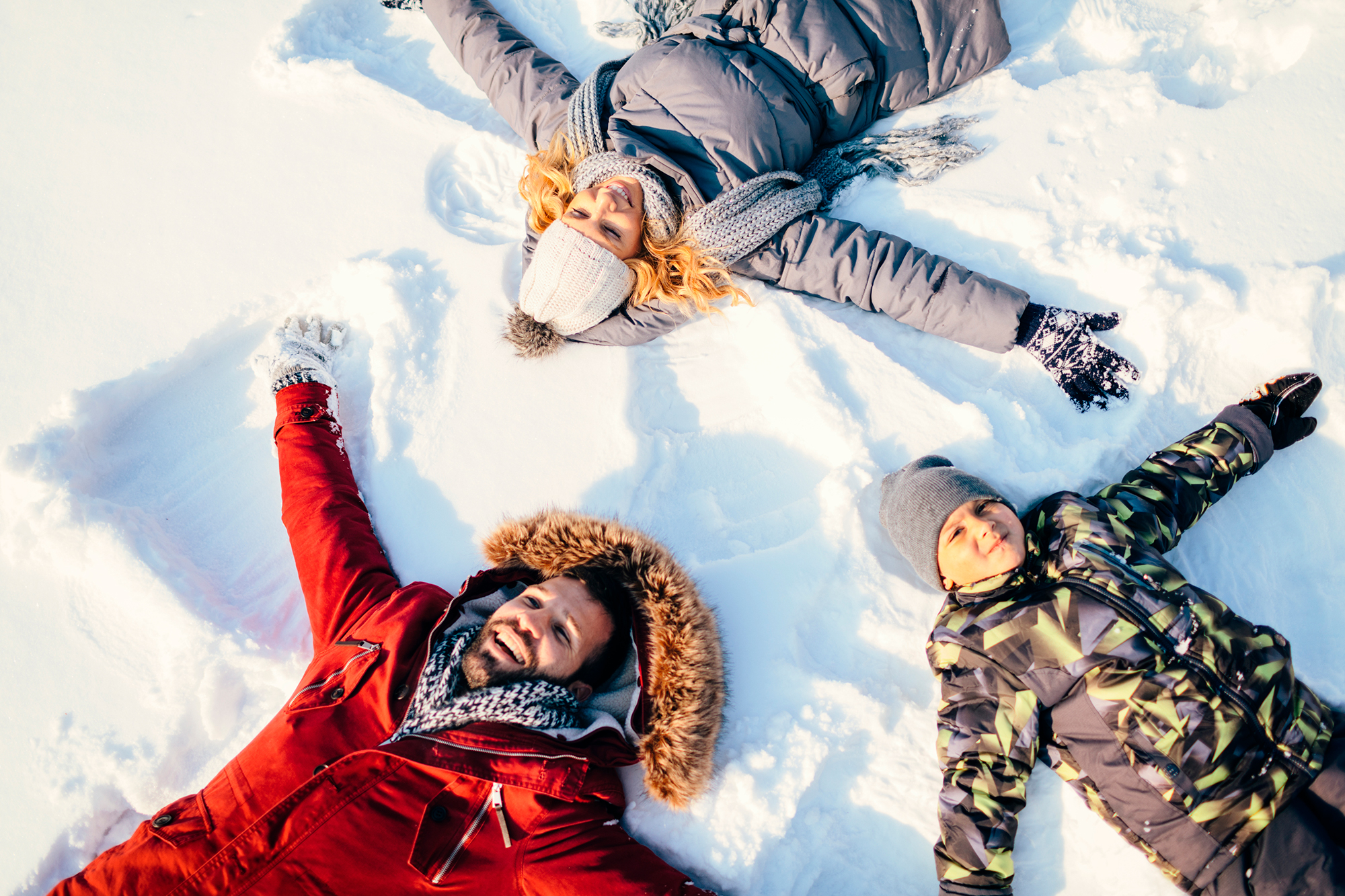 Family making snow angels