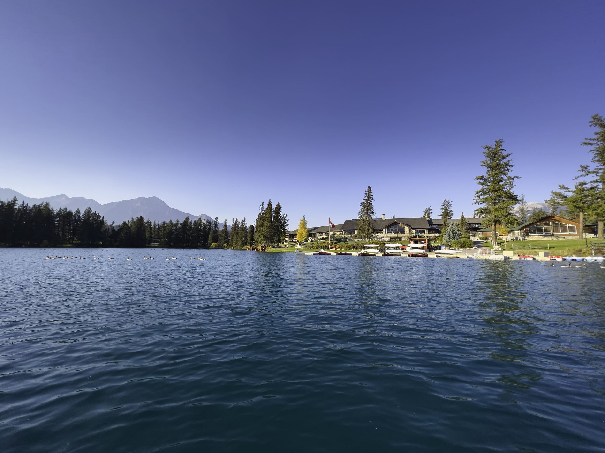 lake boat house by mountains