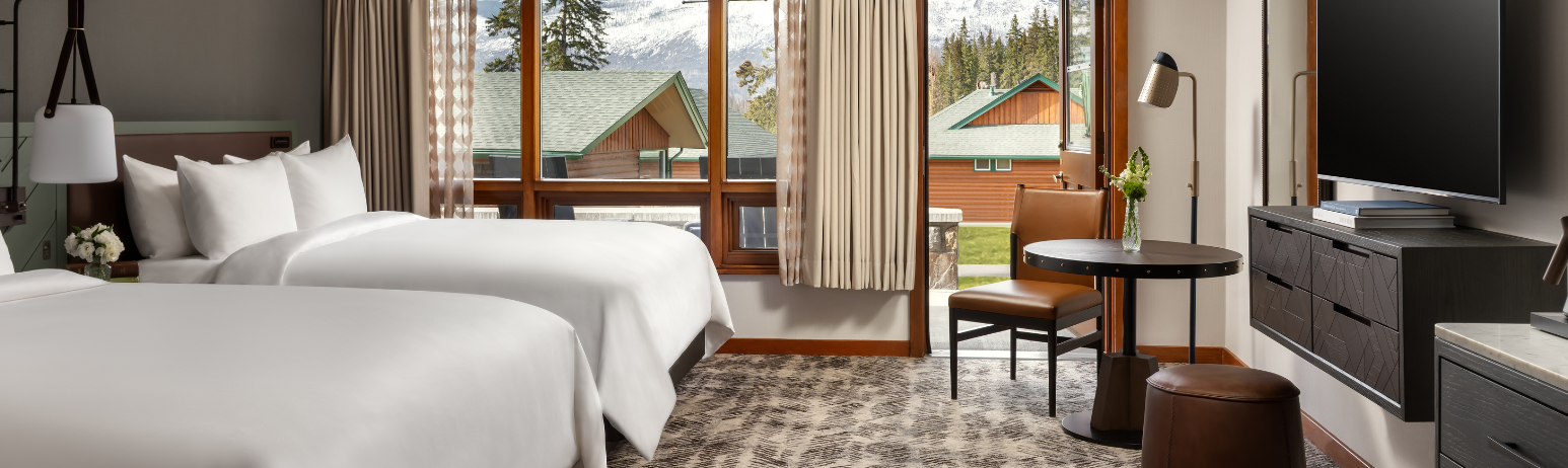 A hotel room with two queen size beds.