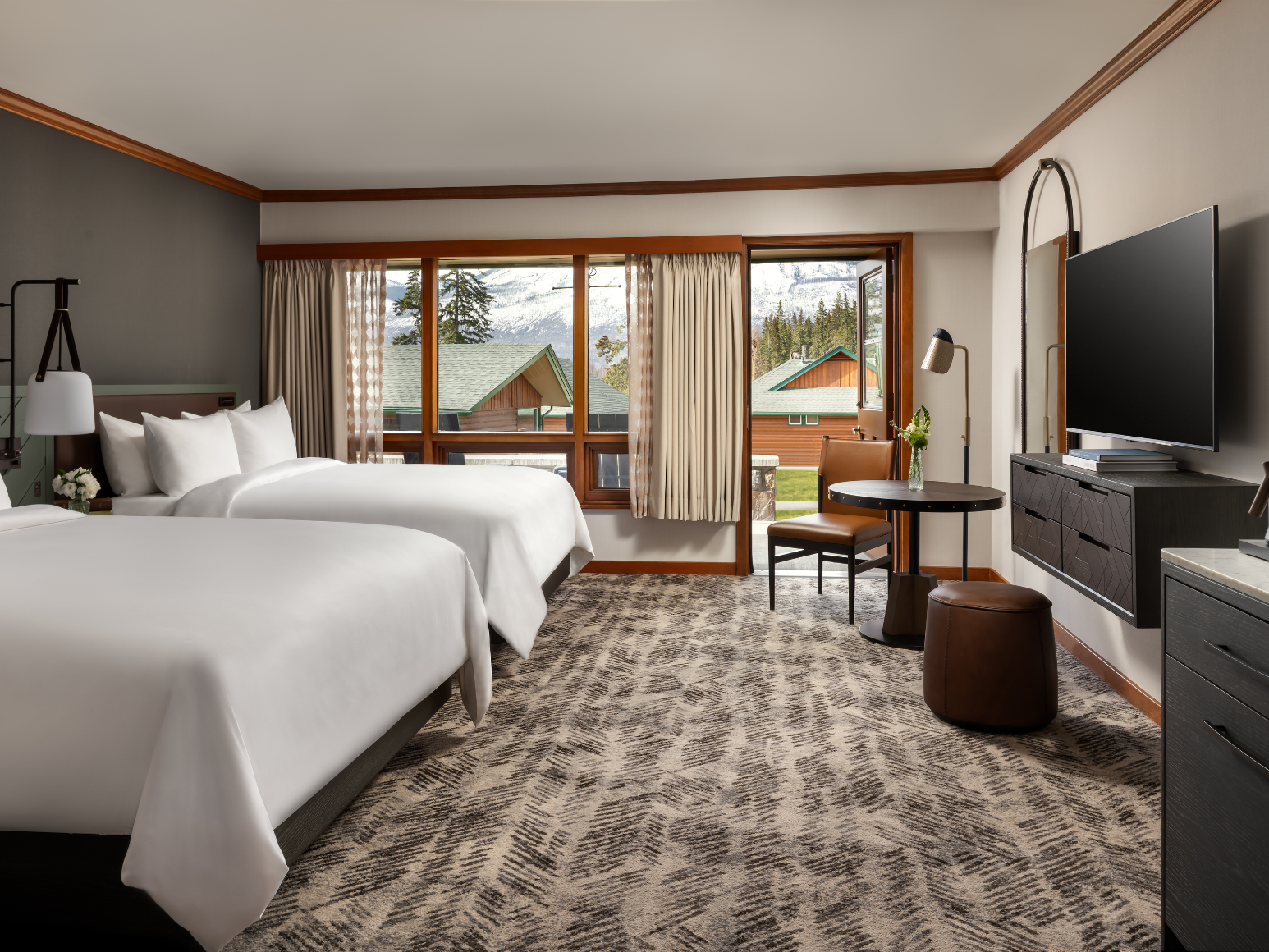 A hotel room with two queen size beds.