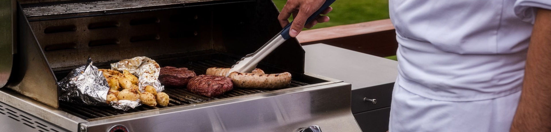chef grilling meats outside