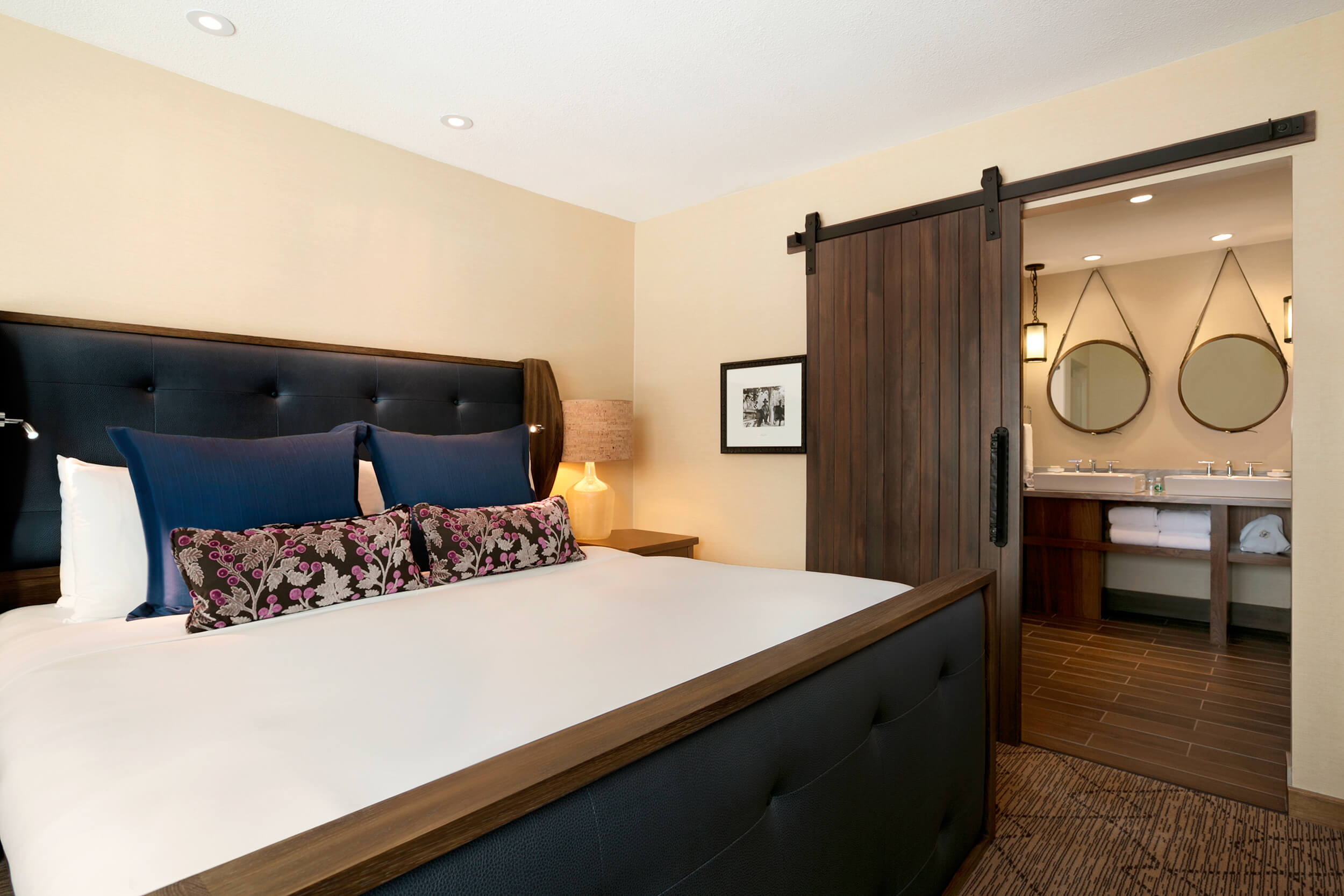 bedroom with barn door to the bathroom