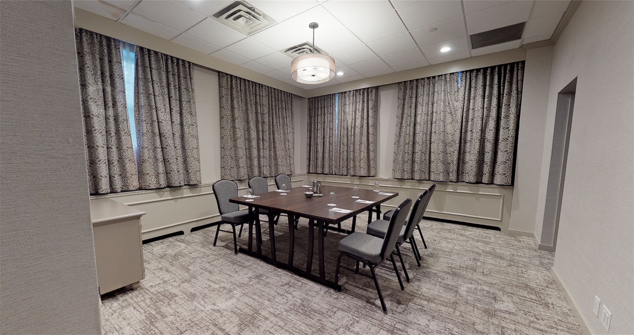 small room with table set for a meeting