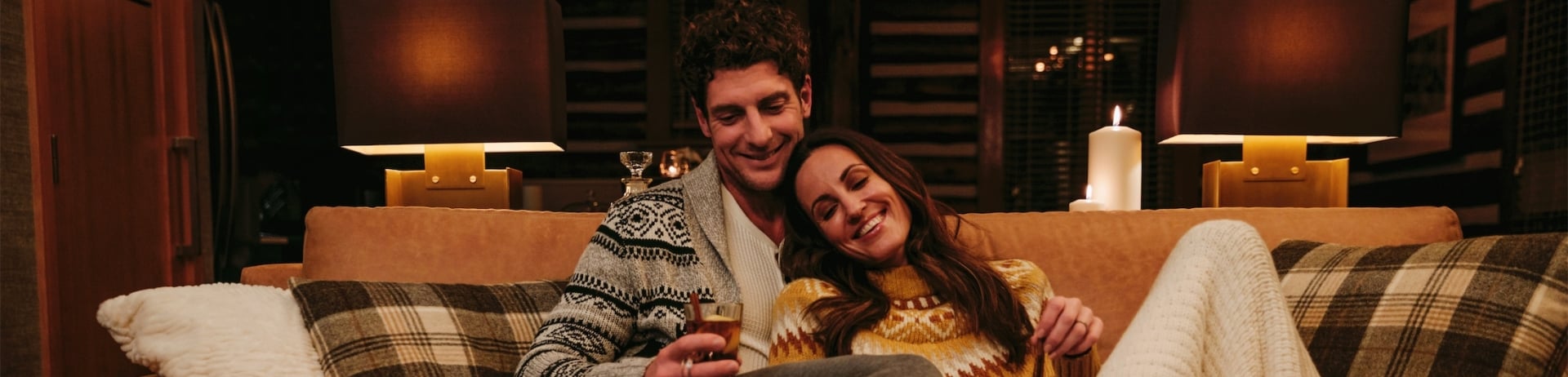 couple relaxing on couch in ridgeline cabin