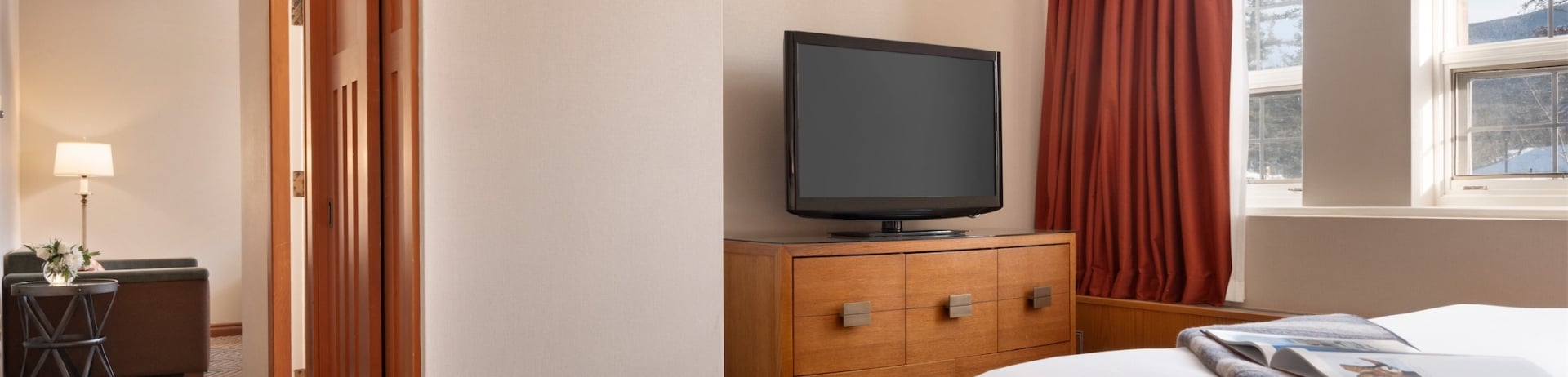 bedroom with tv and small hallway