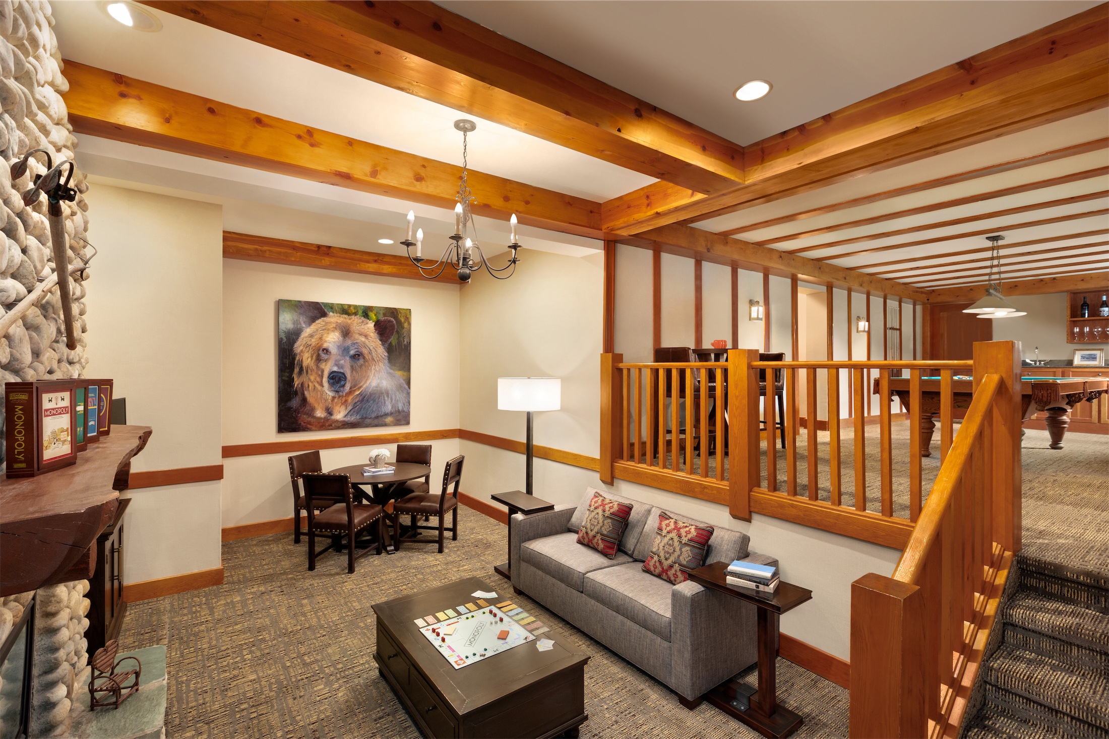 living room with view of the games room with a pool table