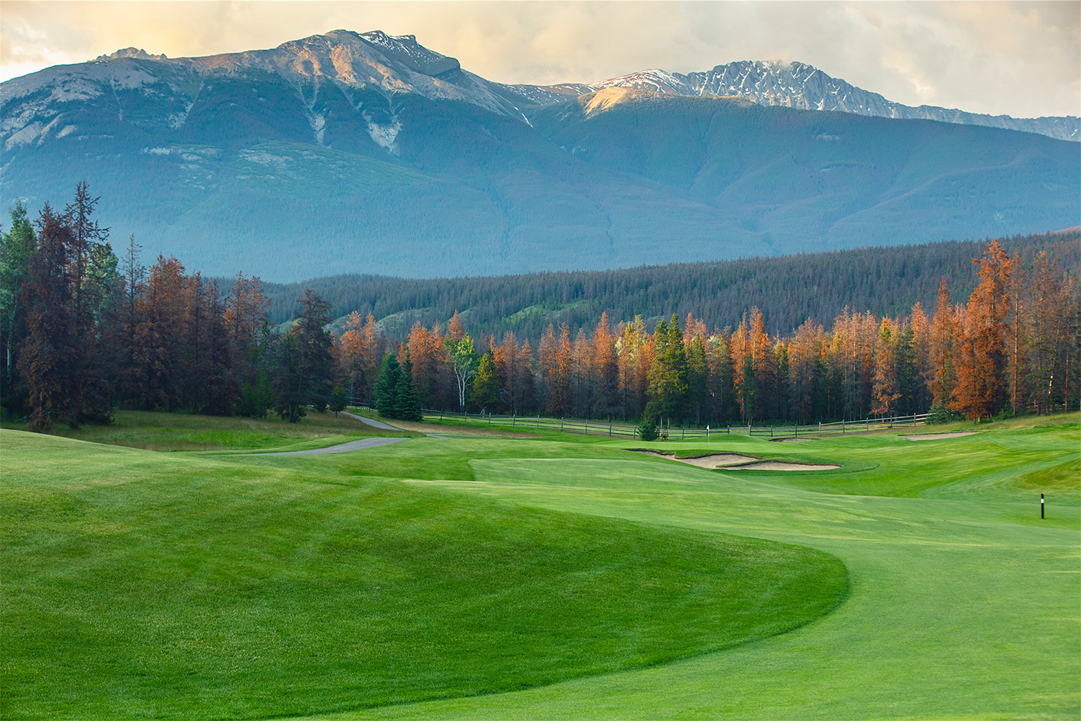 golf course with a view of the mountains