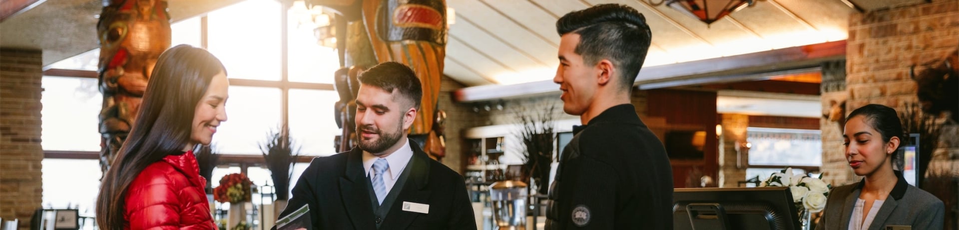 couple and butler talking to guest services