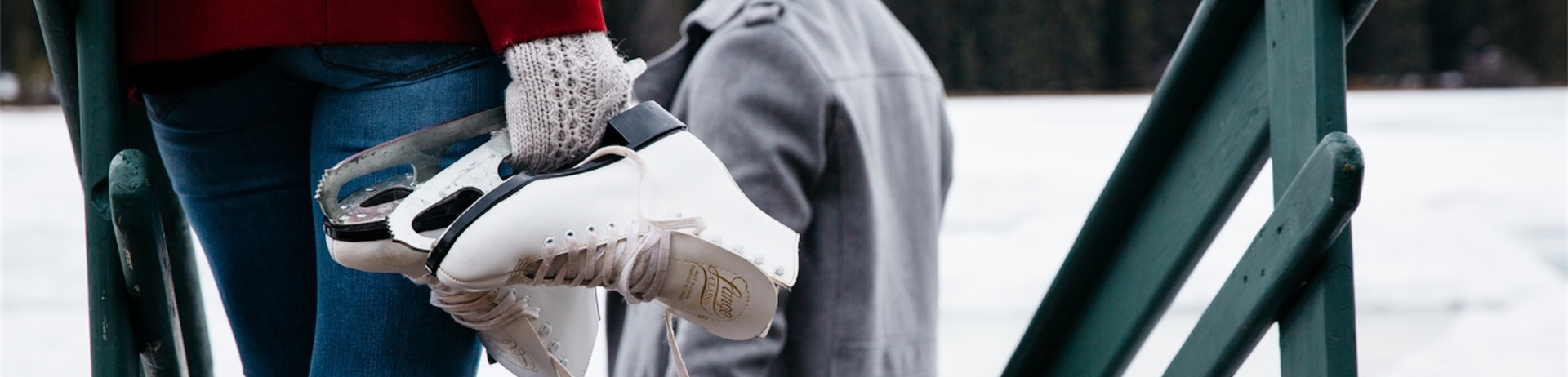 people holding skates down stairs to a frozen lake mildred at jasper park lodge