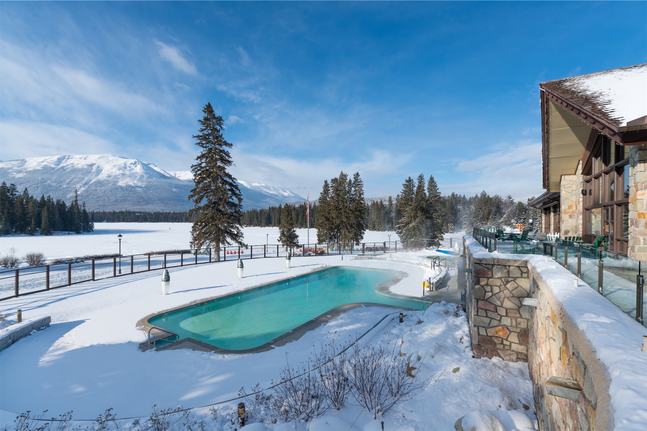 outside pool in winter next to mountains