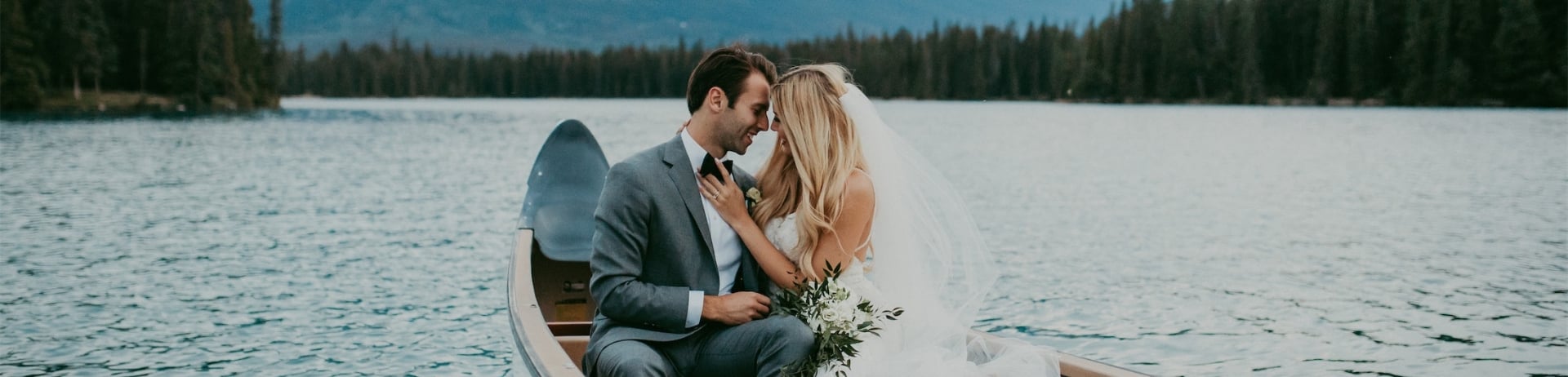 groom and bride in canoe on lake