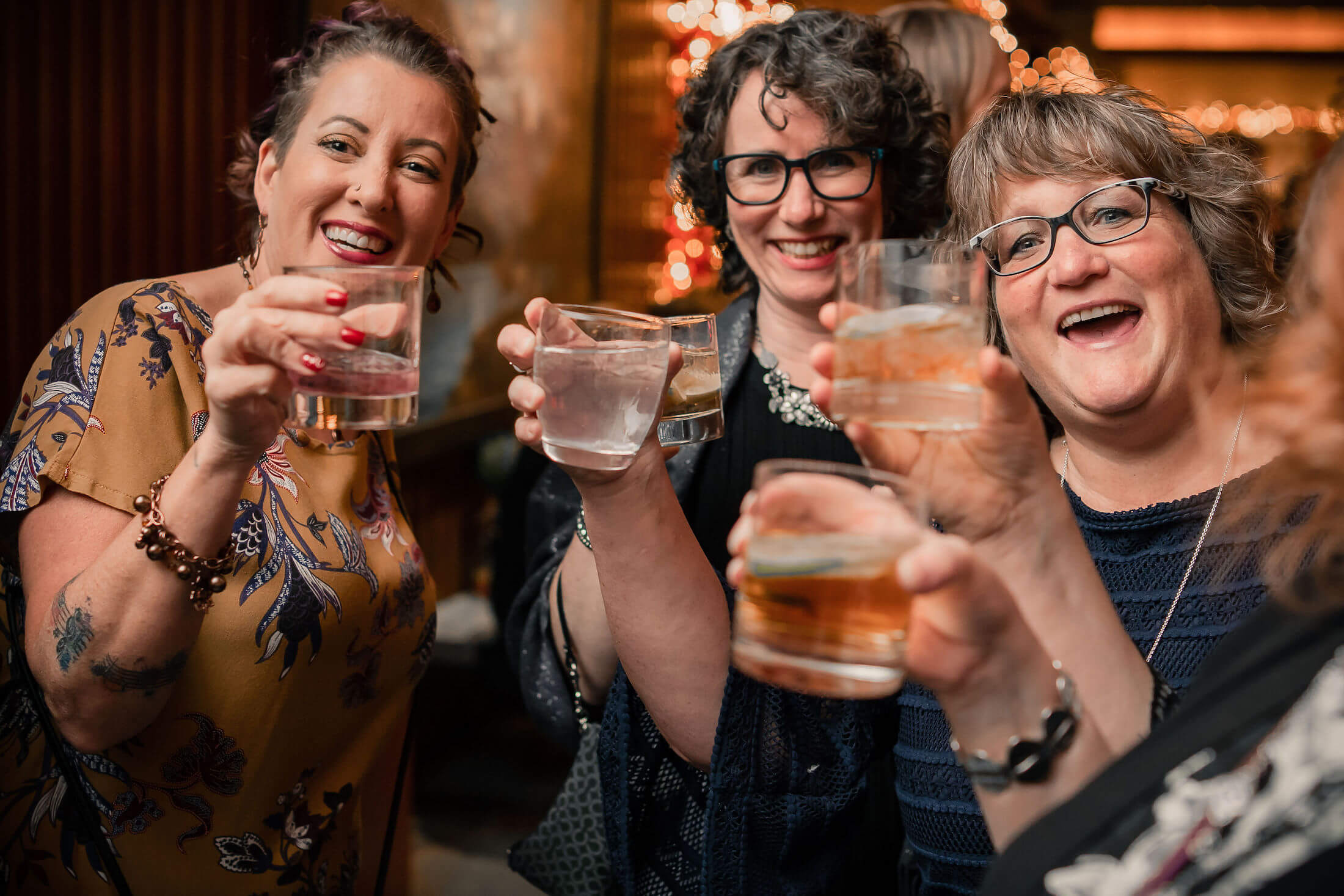 group of women toasting with drinks