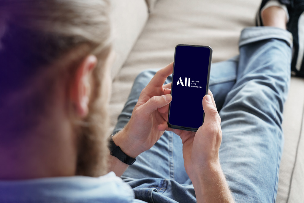 A person looking at Accor's loyalty program on their cell phone
