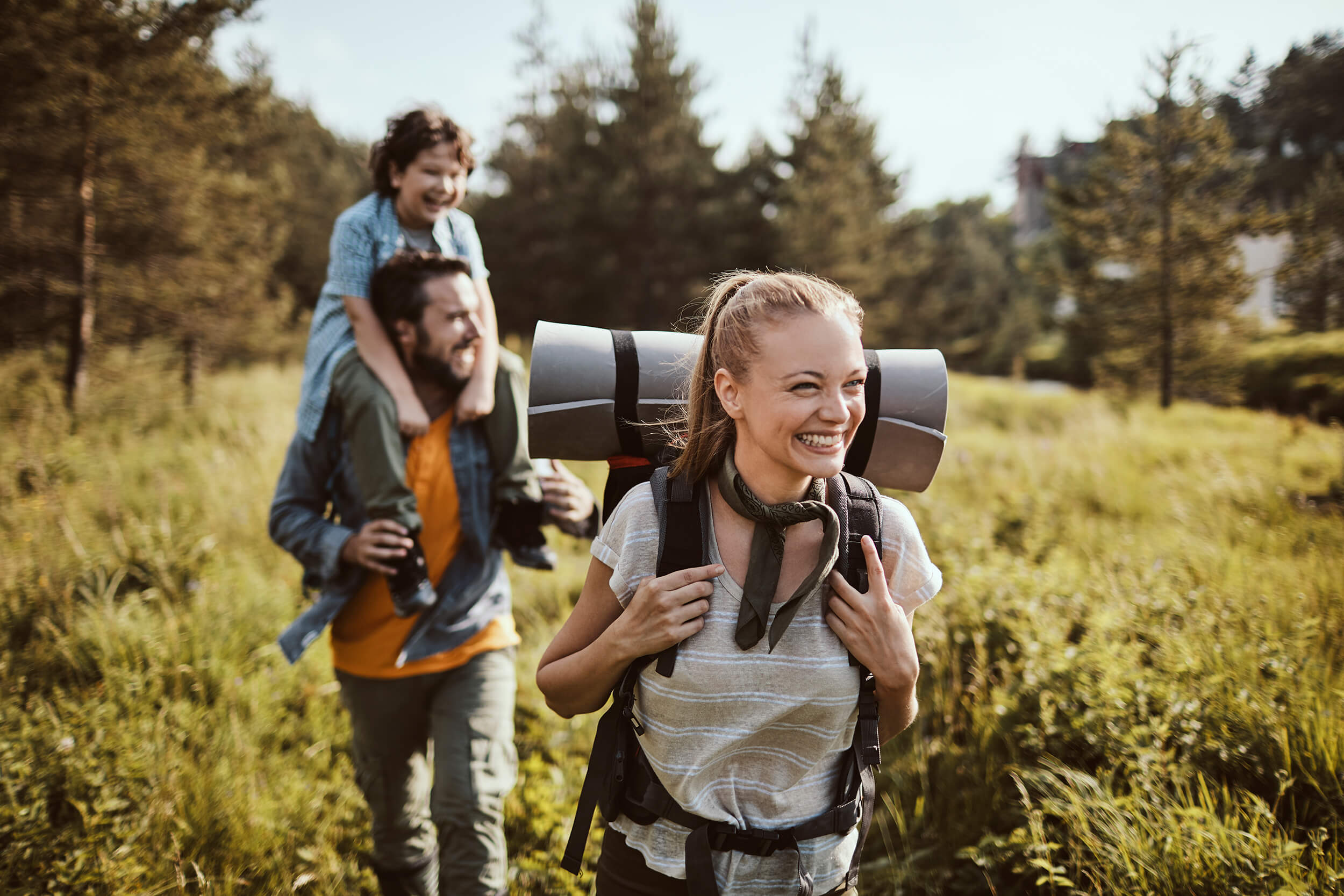 smiling family going on a hike