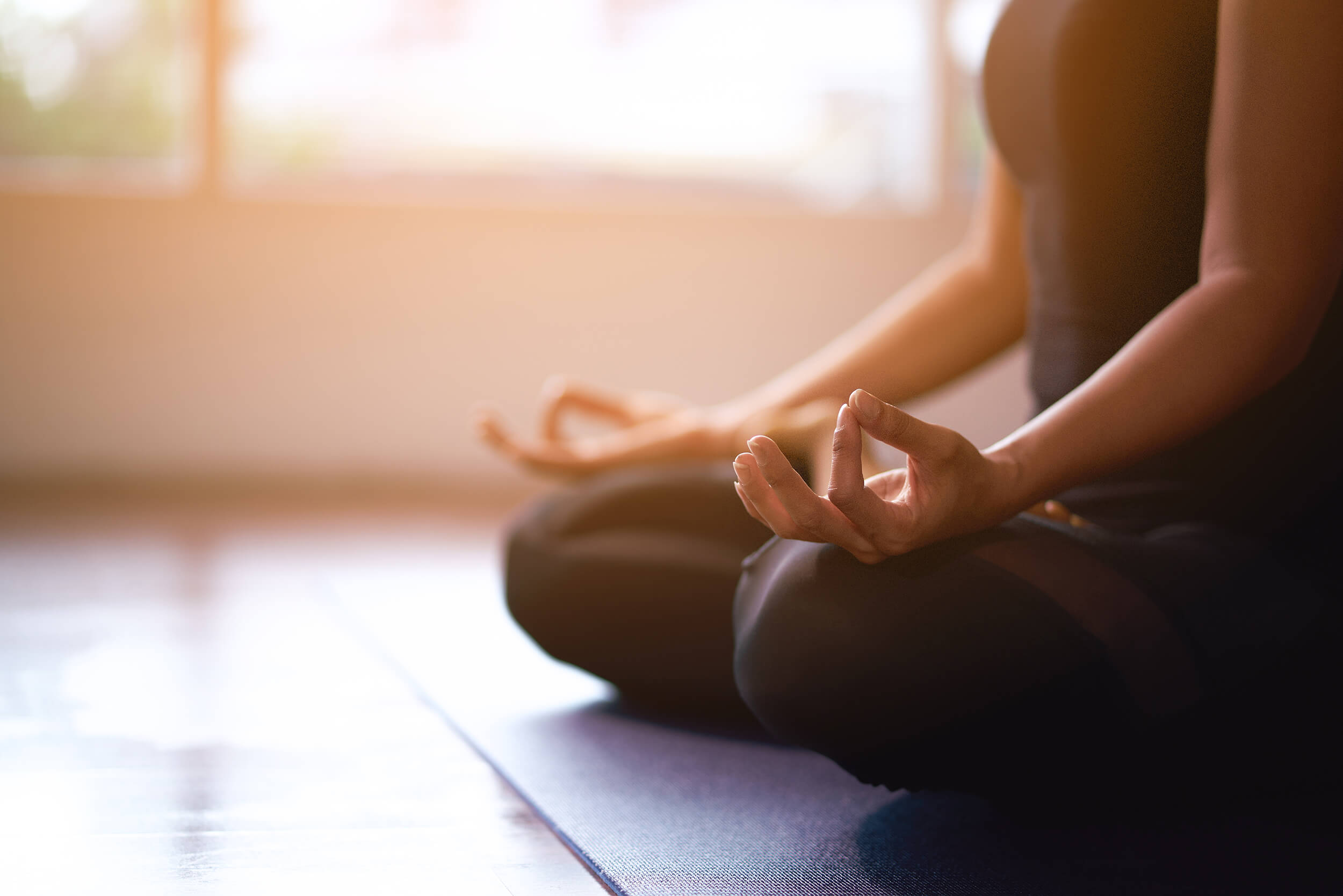 woman meditating on yoga mat