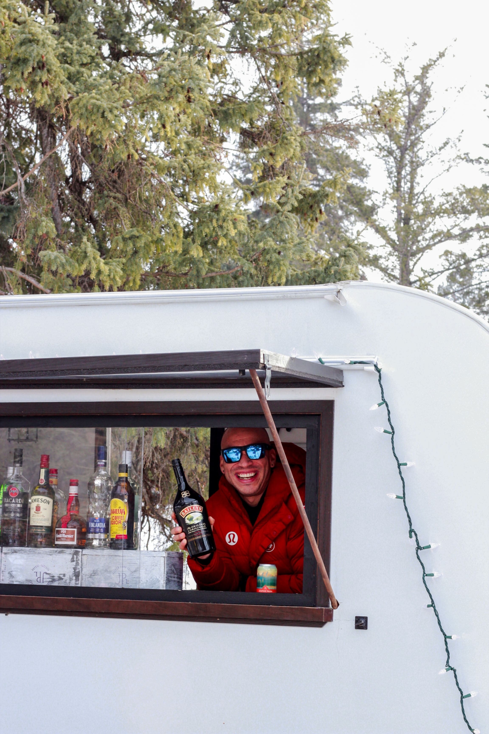 A bartender operating out of a food truck during winter