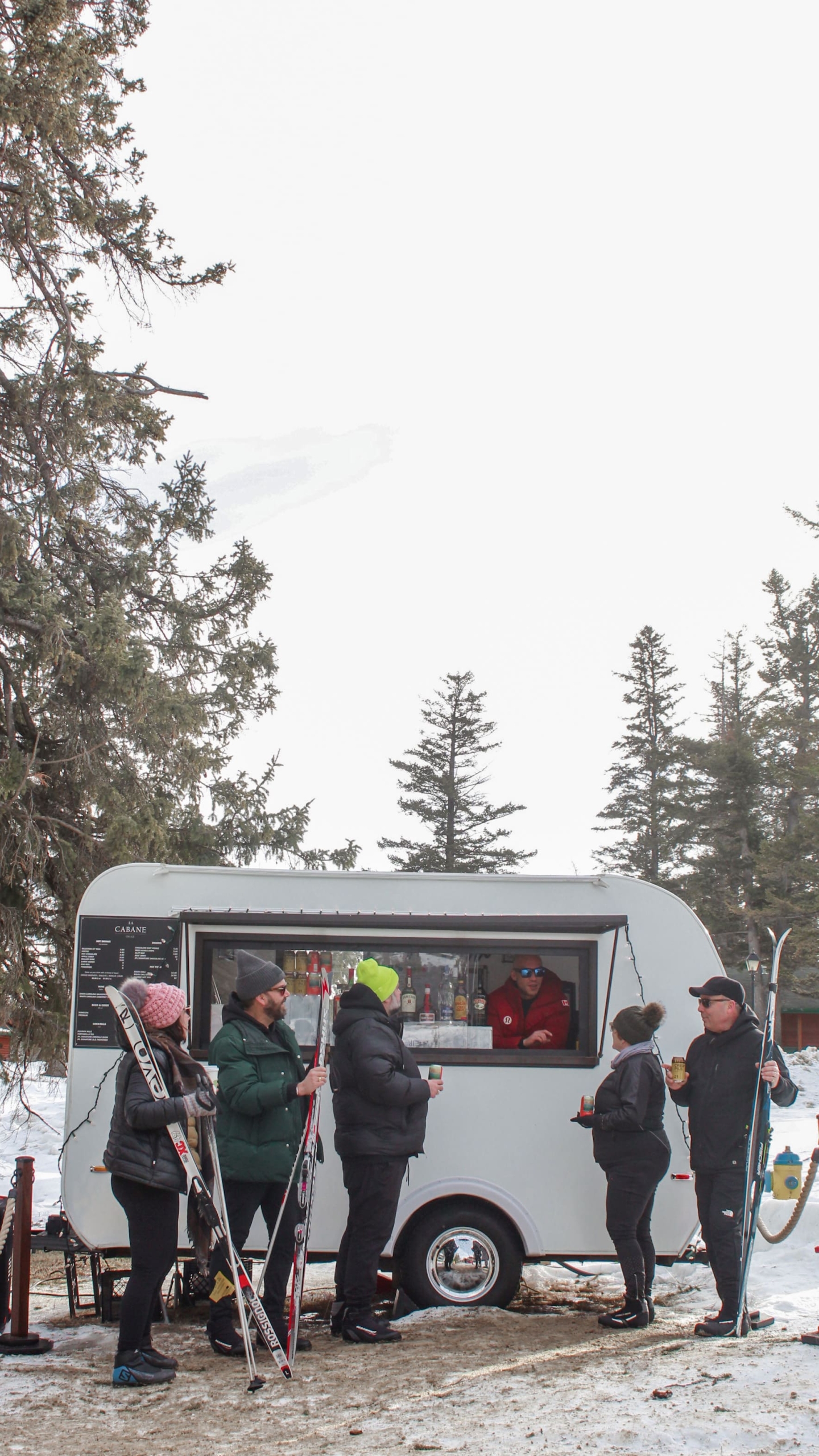 Skiers getting drinks from a food truck