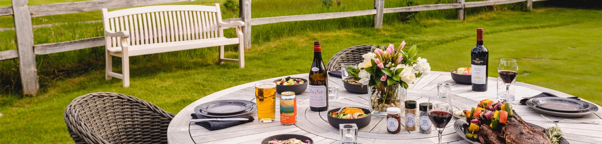 A rustic outdoor table set for a bbq