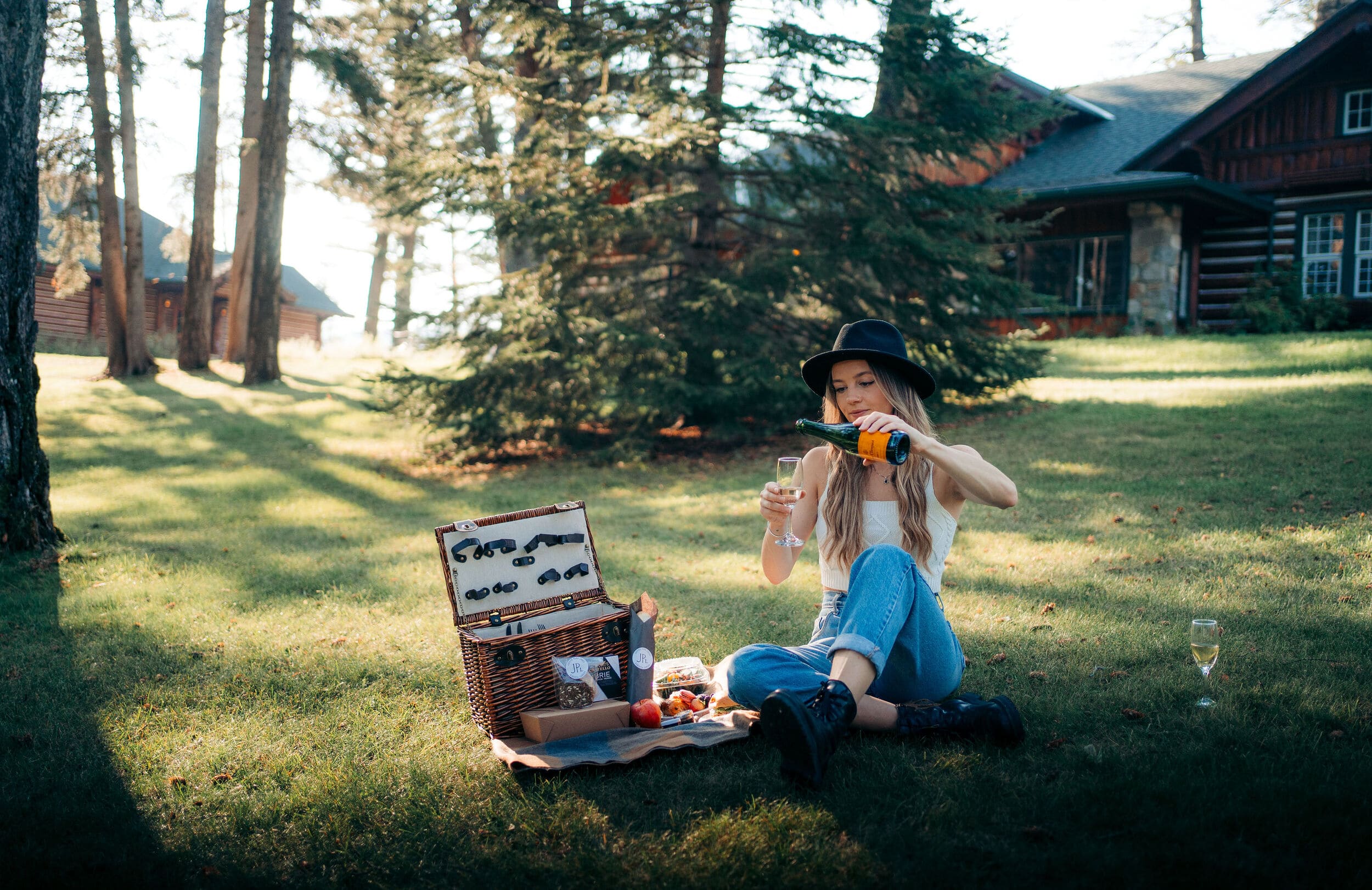 woman pouring wine by cabin
