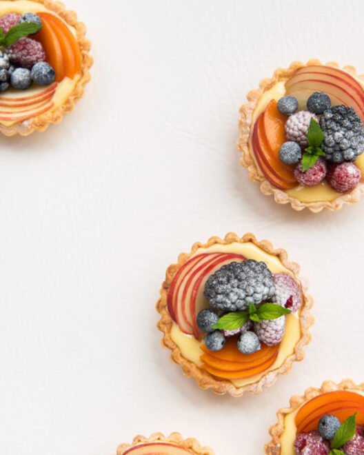 A few fruit tartlets on a white background
