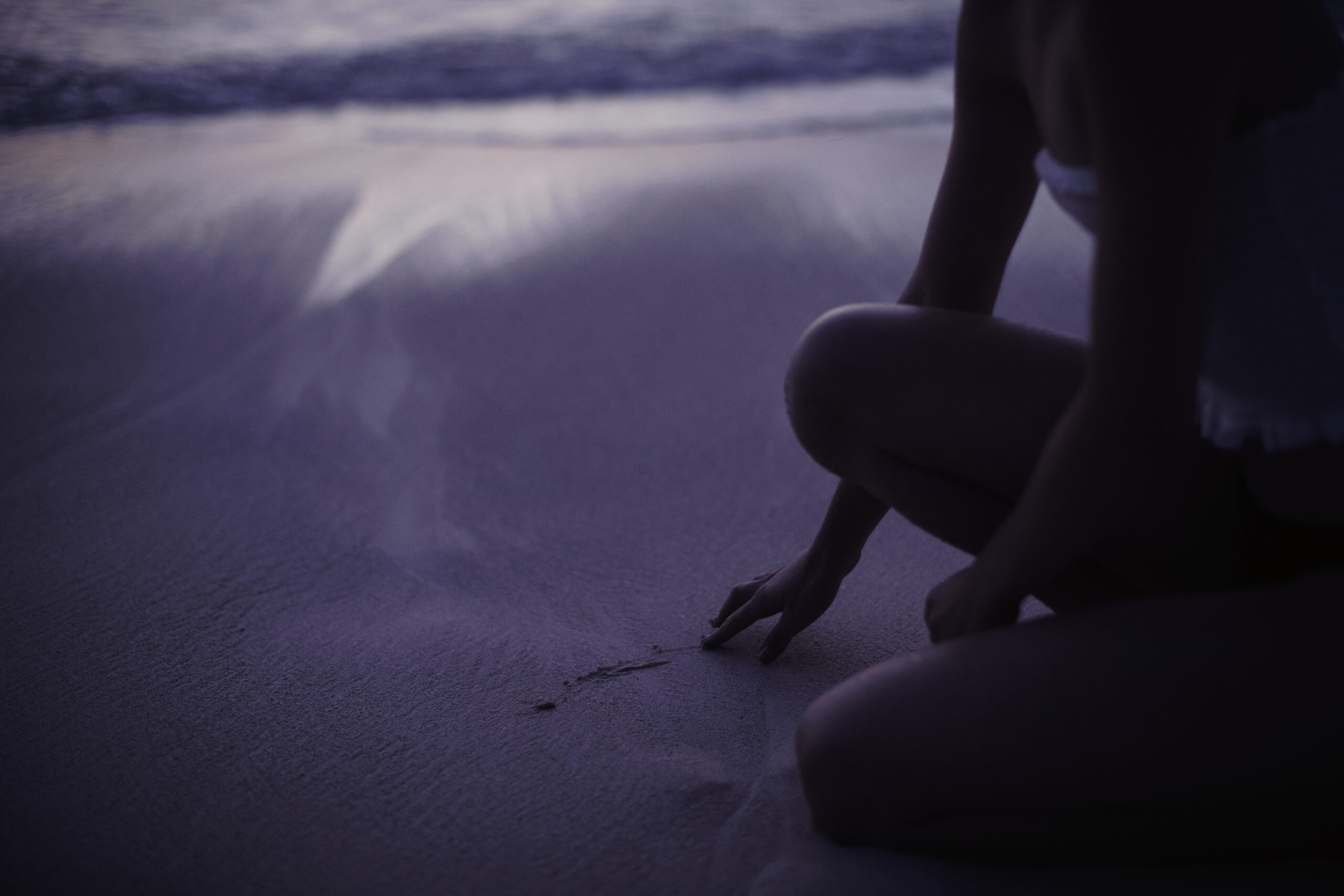 woman drawing in the sand