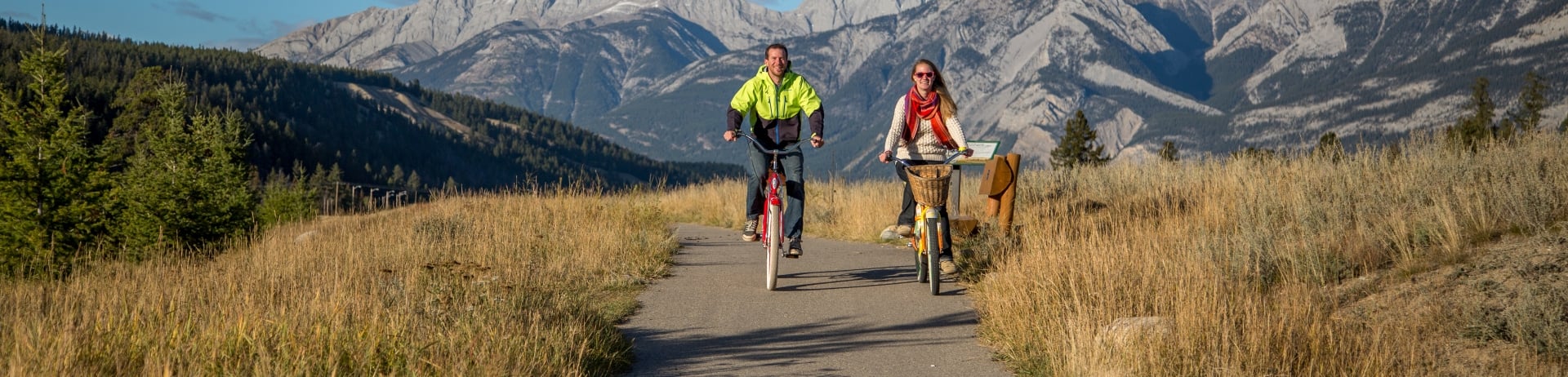 two young adults riding bikes along easy jasper trails