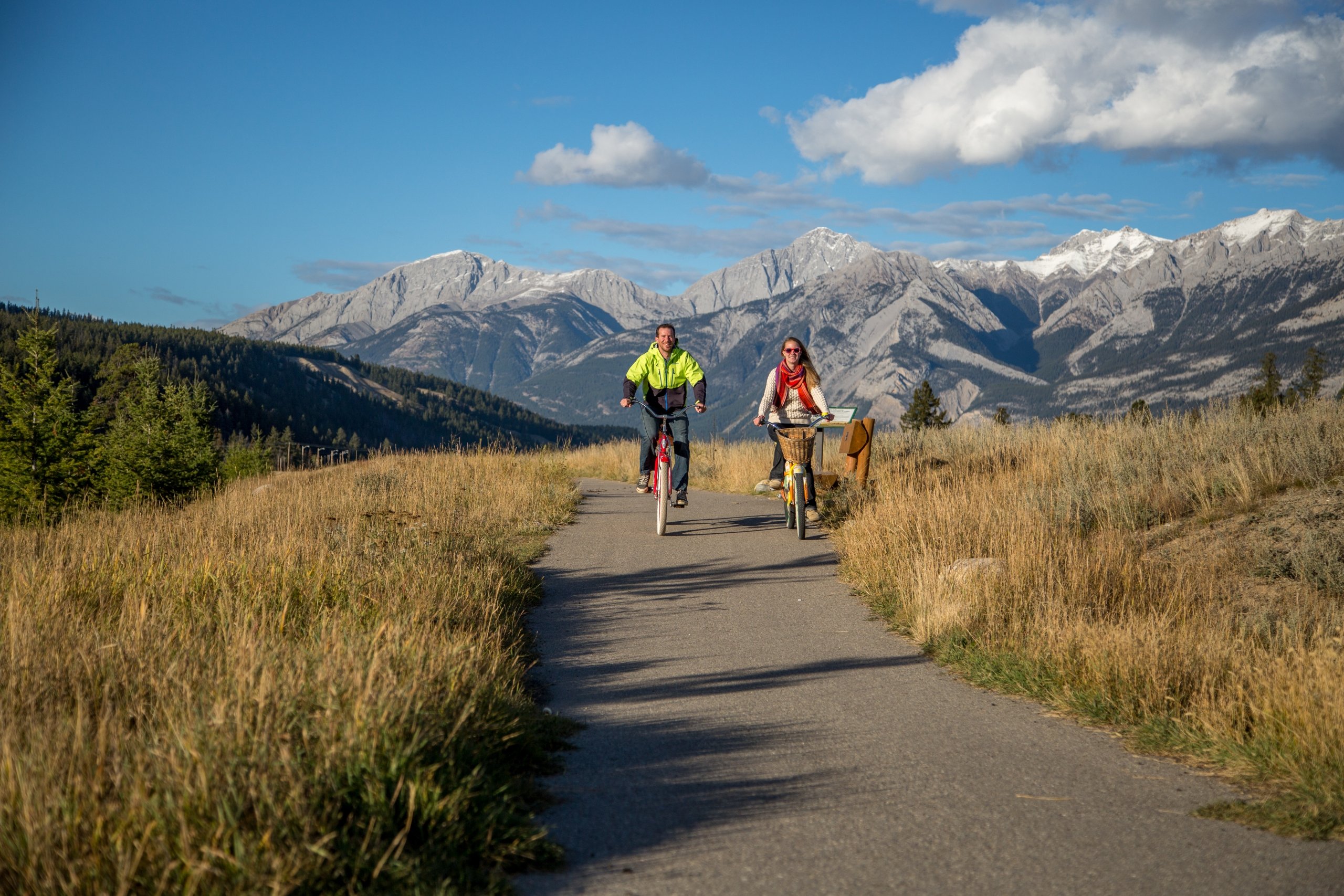 two young adults riding bikes along easy jasper trails