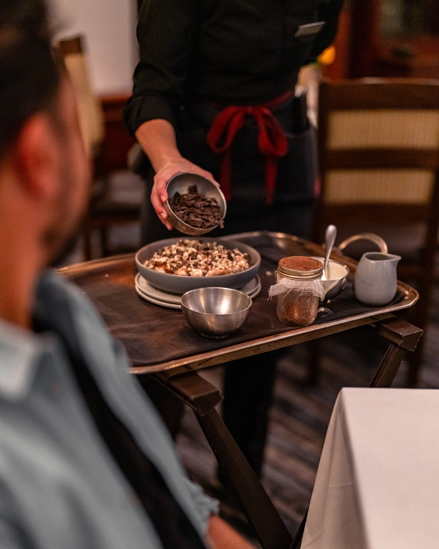 Chef serving tiramisu to guests