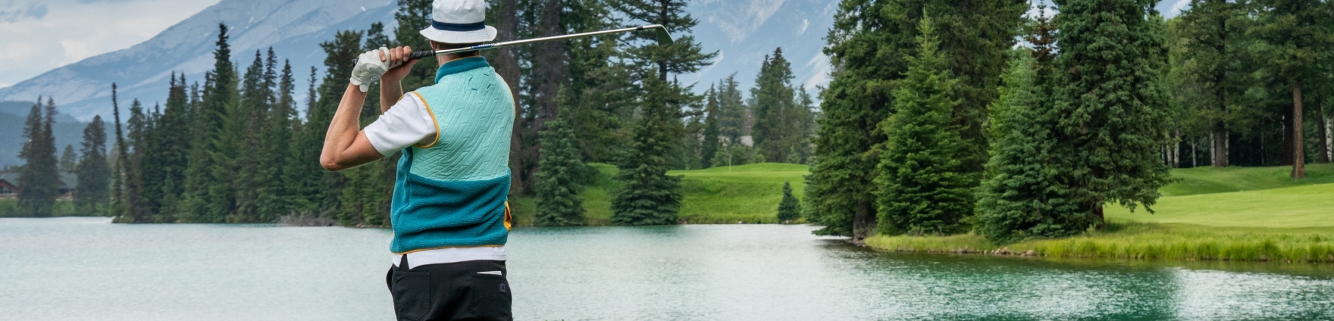 Golfer watching ball on the course at Fairmont Jasper Park Lodge Golf Club
