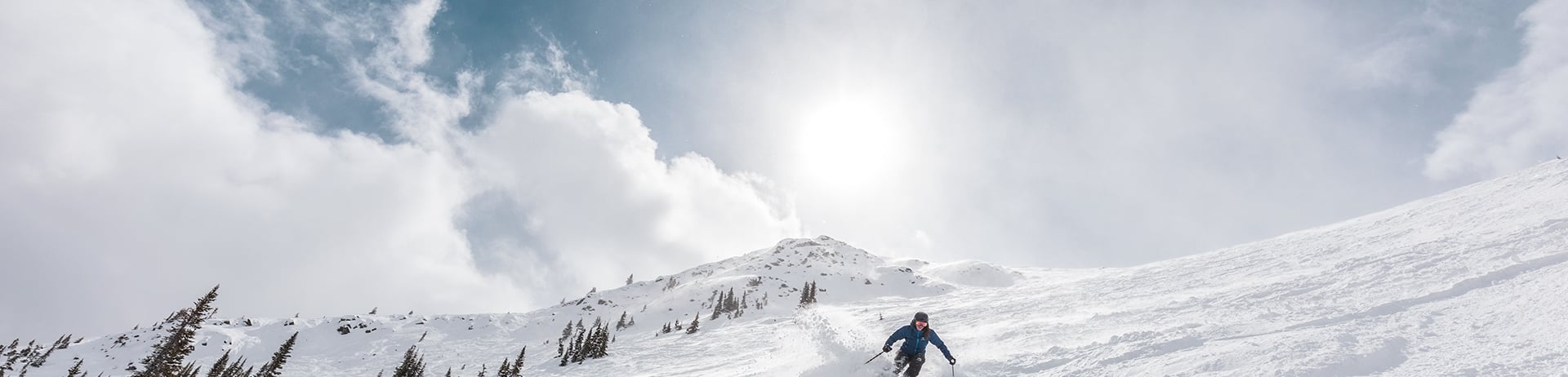 Skier skiing downhill at Marmot Basin in Jasper National Park, Canada.