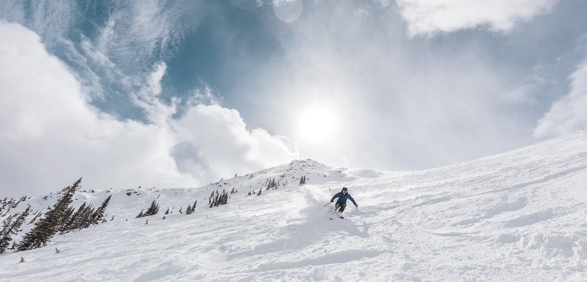 Skier skiing downhill at Marmot Basin in Jasper National Park, Canada.