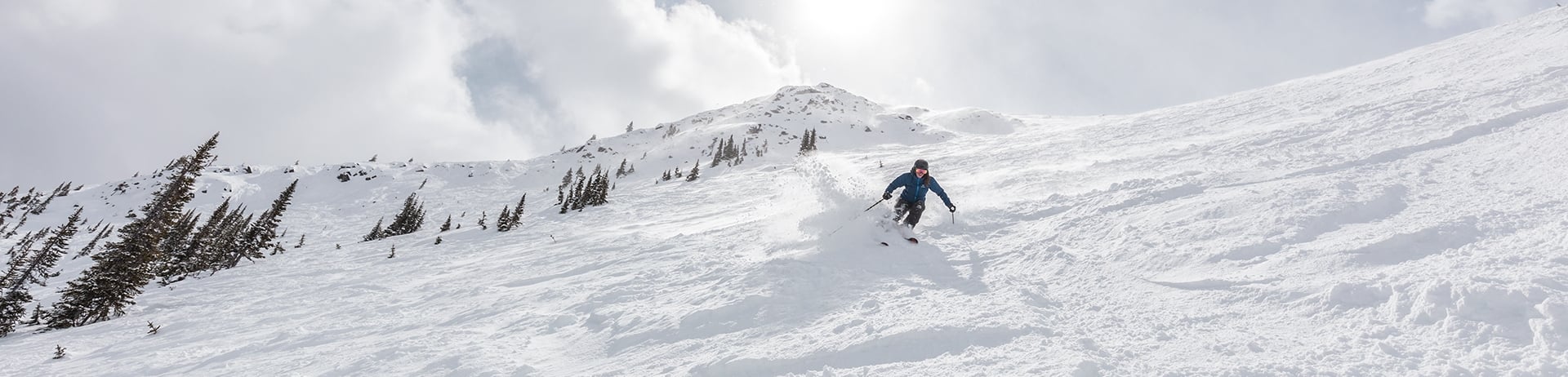 Skier skiing downhill at Marmot Basin in Jasper National Park, Canada.