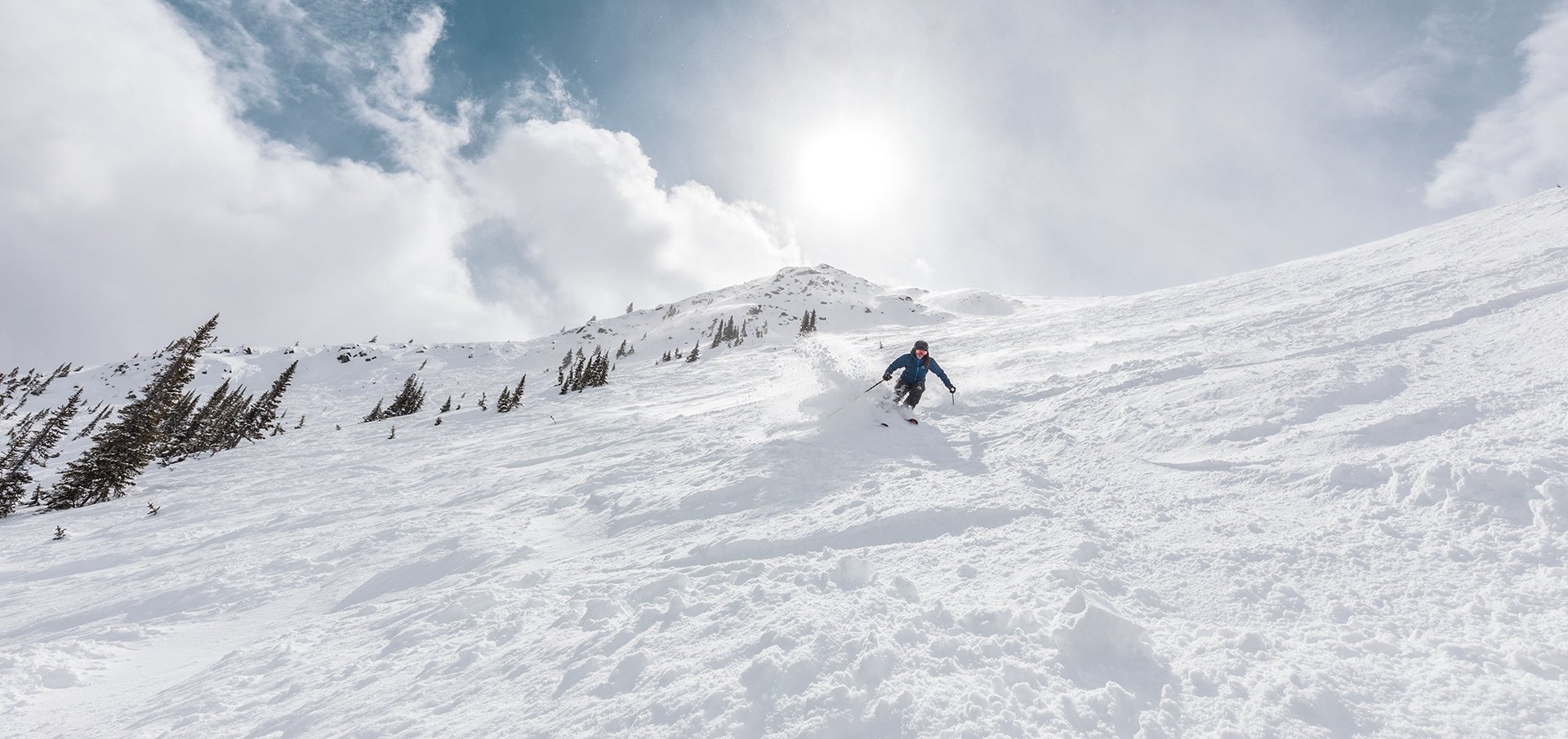 Skier skiing downhill at Marmot Basin in Jasper National Park, Canada.