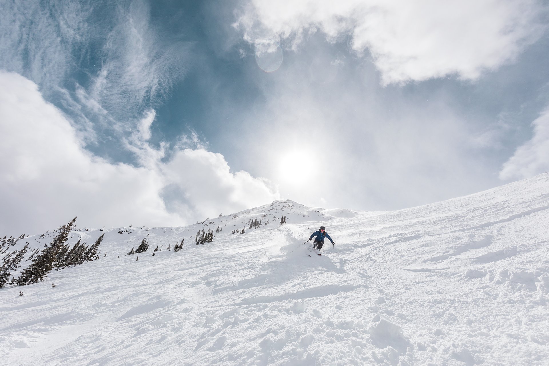Skier skiing downhill at Marmot Basin in Jasper National Park, Canada.
