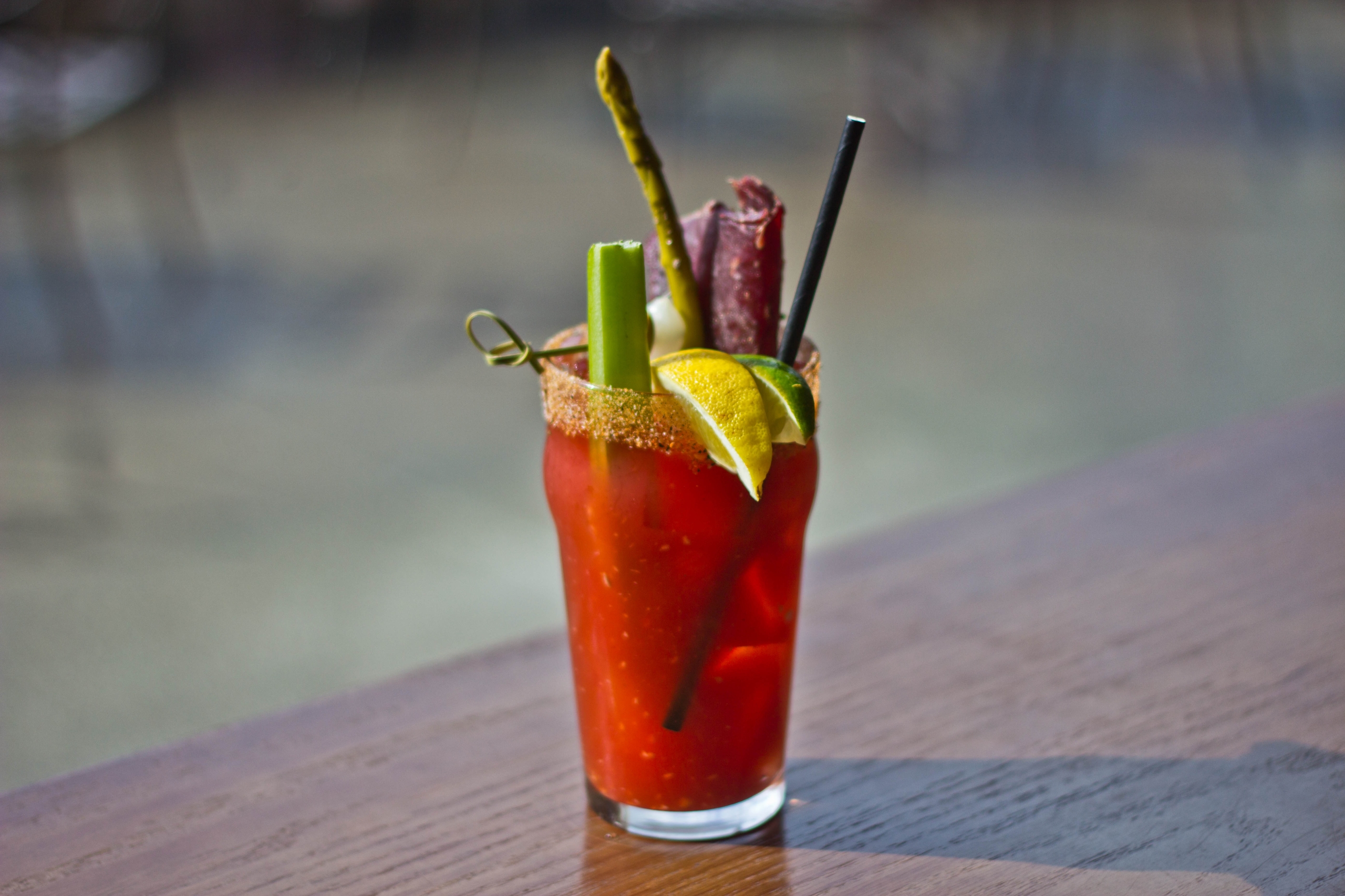 Photo of The Emerald Lounge signature Mountain Caesar with garnishes including beef jerky, pickled asparagus, celery.