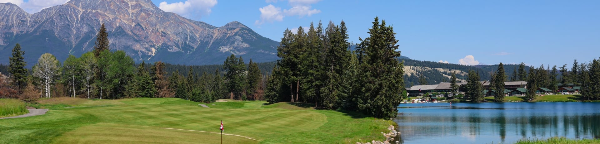 Scenic photo from Hole 16 on the Fairmont Jasper Park Lodge Golf Course with a view of the greens and main lodge.