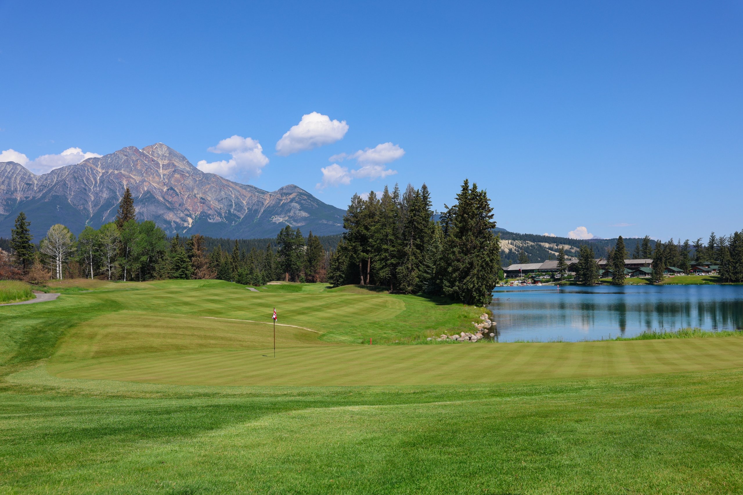 Scenic photo from Hole 16 on the Fairmont Jasper Park Lodge Golf Course with a view of the greens and main lodge.