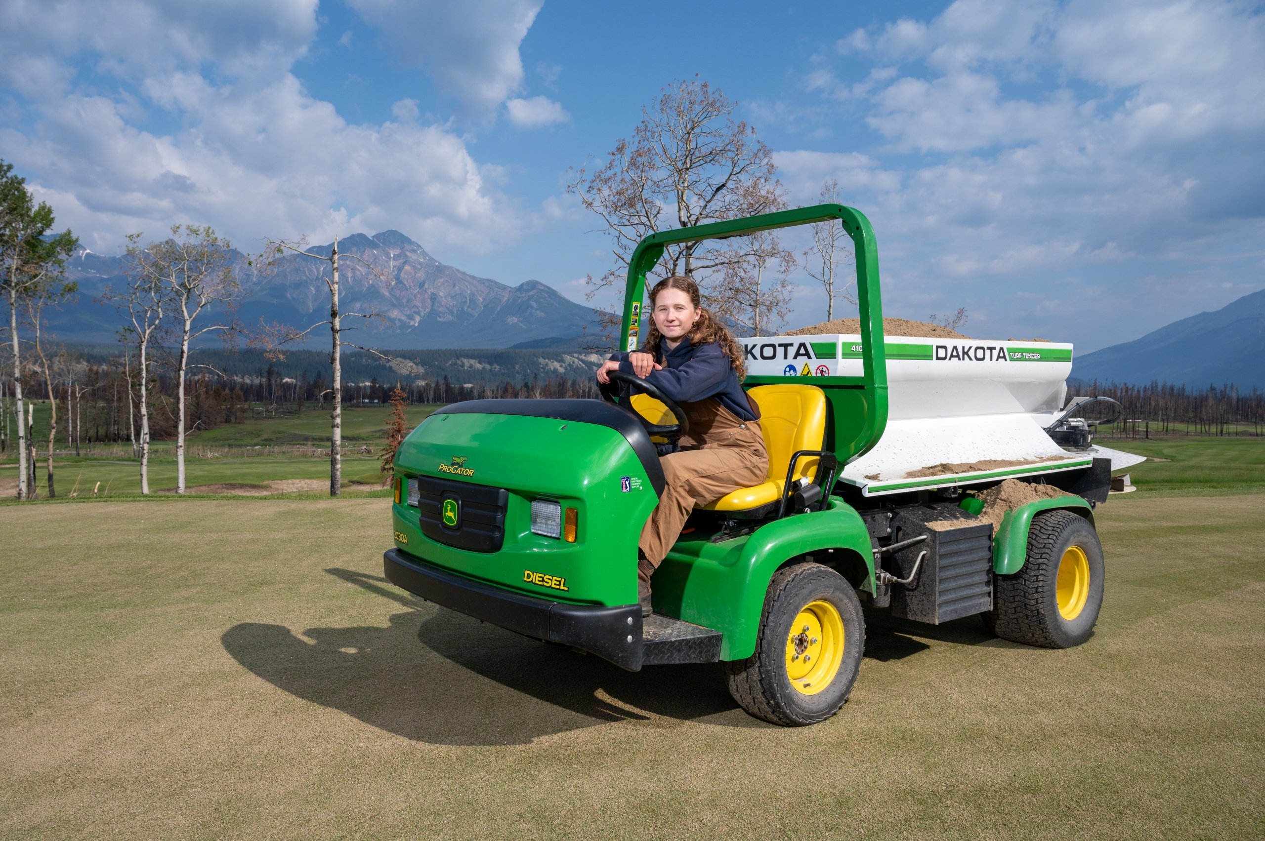 Images of the Grounds Irrigation Supervisor in front of a vehicle at Fairmont Jasper Park Lodge Golf Course
