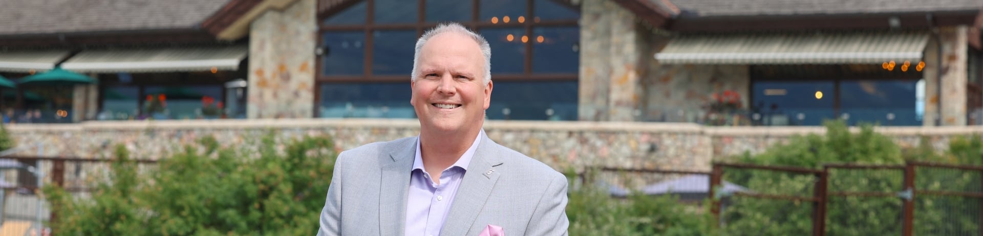 Fairmont Jasper Park Lodge General Manager Garrett Turta standing proudly in front of the resort.