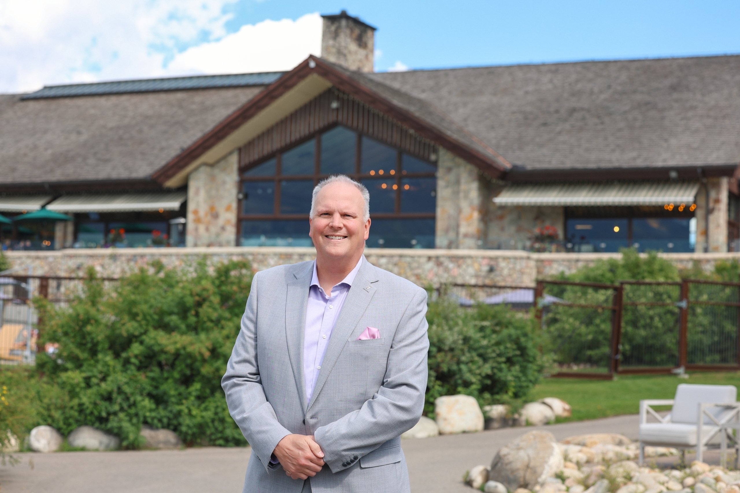 Fairmont Jasper Park Lodge General Manager Garrett Turta standing proudly in front of the resort.