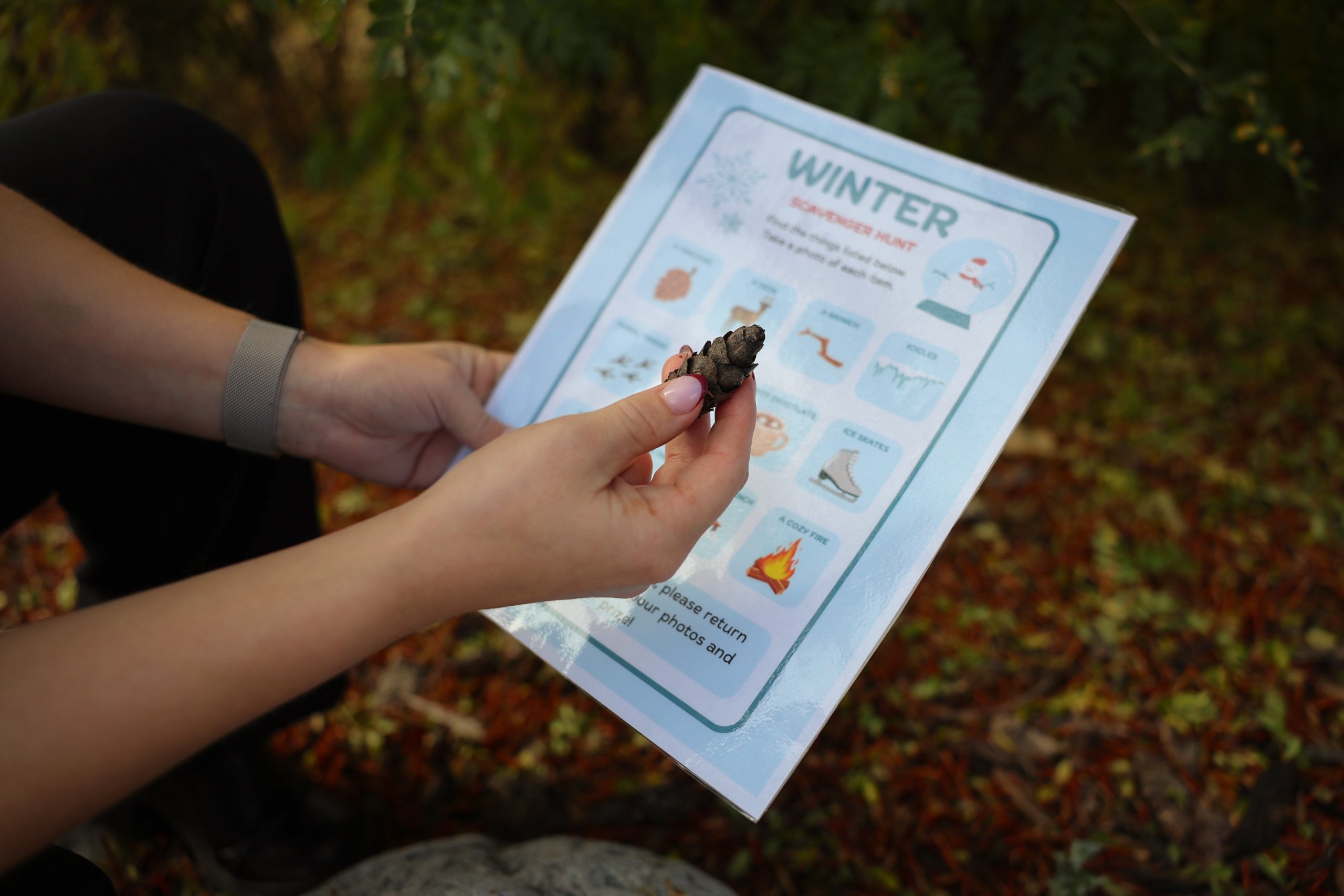 A guest finding a clue during a winter scavenger hunt.