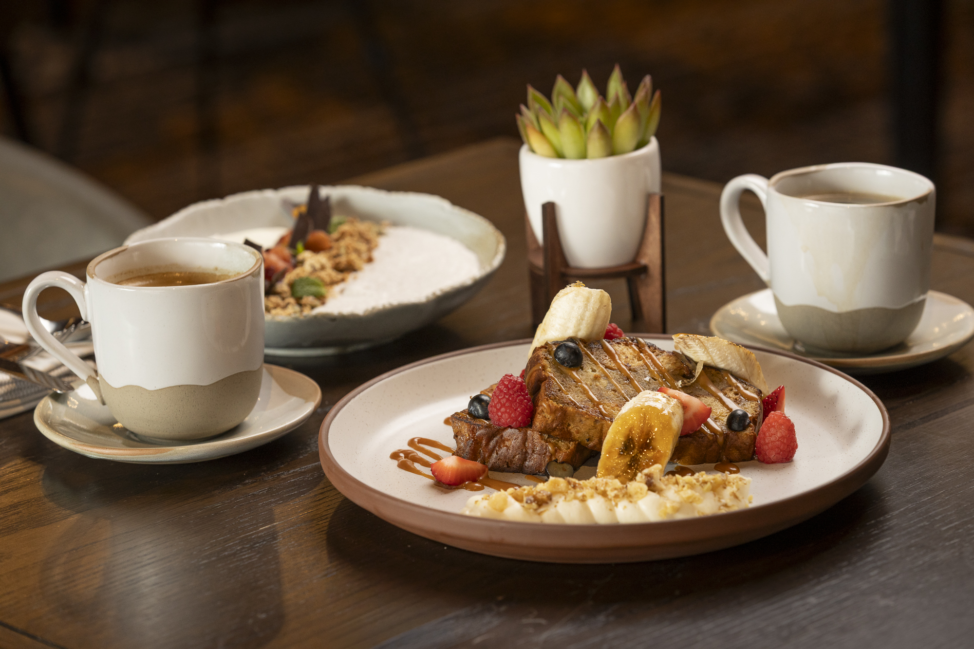 Banana Brûlée Toast adorned with Berries, Banana, Walnuts, Caramel Sauce, and Mascarpone Vanilla Whipped Cream. Berries | Banana | Walnuts, Caramel Sauce, and Mascarpone Vanilla Whipped Cream