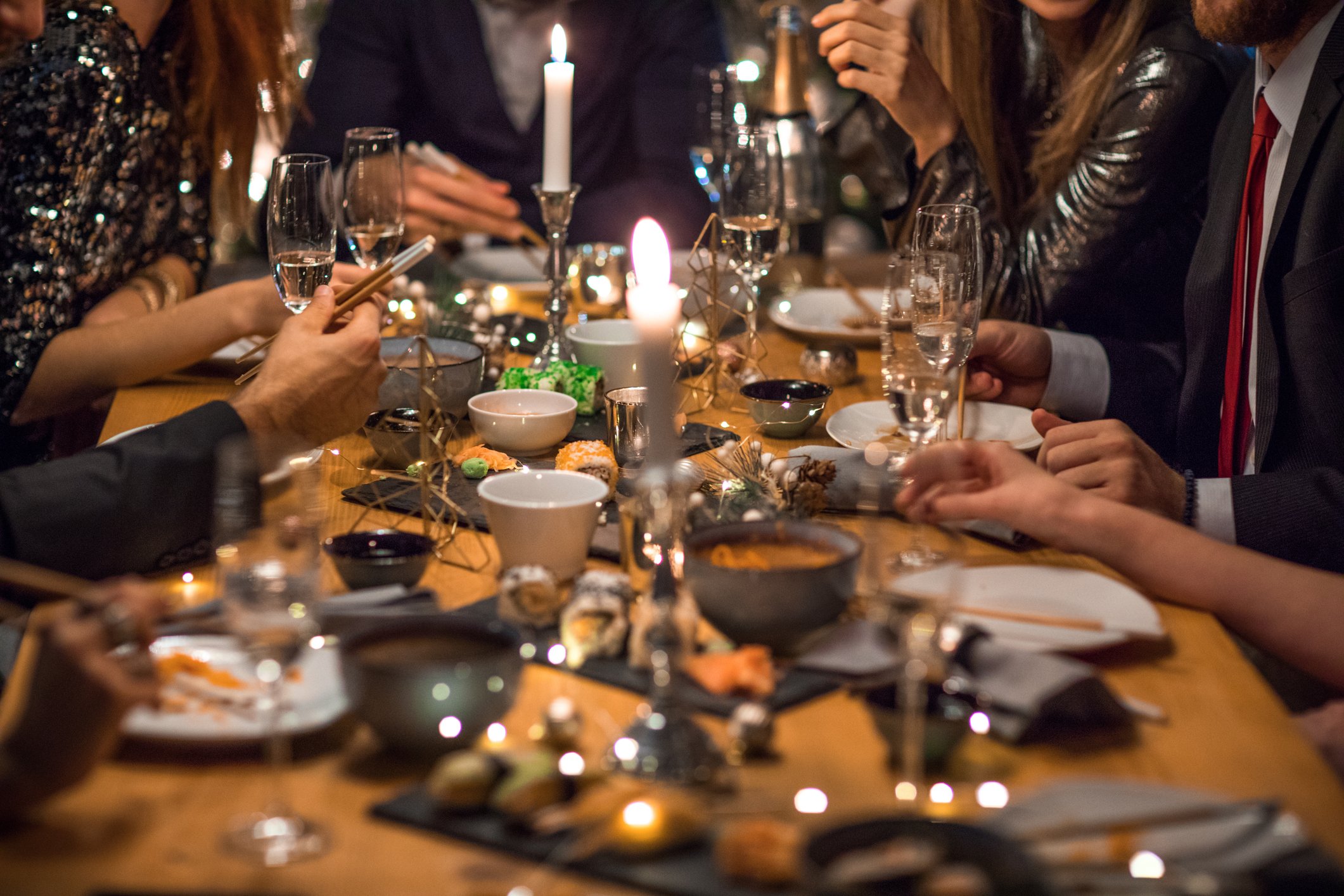 Group of friends celebrating New Year's Eve, everyone enjoy in party dinner, drinking and smiling